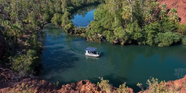 ariel view of solar-powered boat on a river