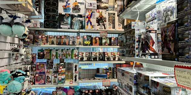 Shelves full of pop culture related collectibles from video games and Japanese anime. 