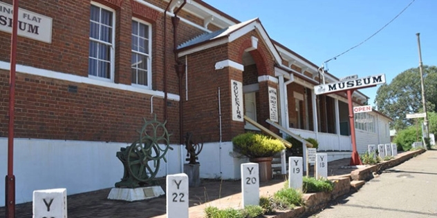 historic red and white brick building with museum sign
